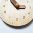 Wooden toy clock with minute and hour in different shades for easy learning