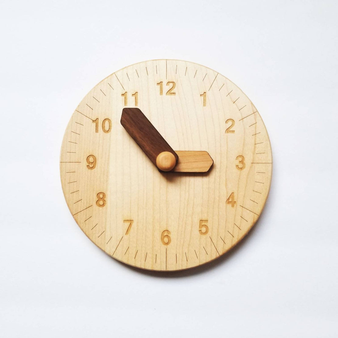 Wooden toy clock with minute and hour in different shades for easy learning