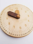 Wooden toy clock with minute and hour in different shades for easy learning