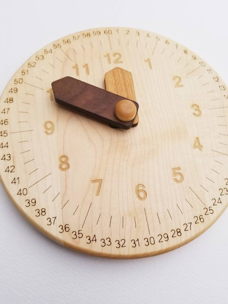 Wooden toy clock with minute and hour in different shades for easy learning