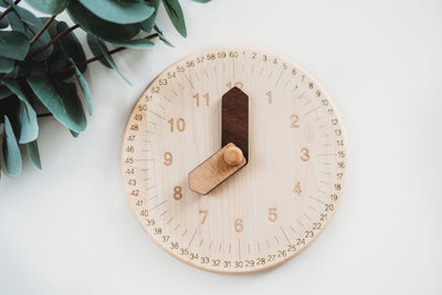 Wooden toy clock with minute and hour in different shades for easy learning